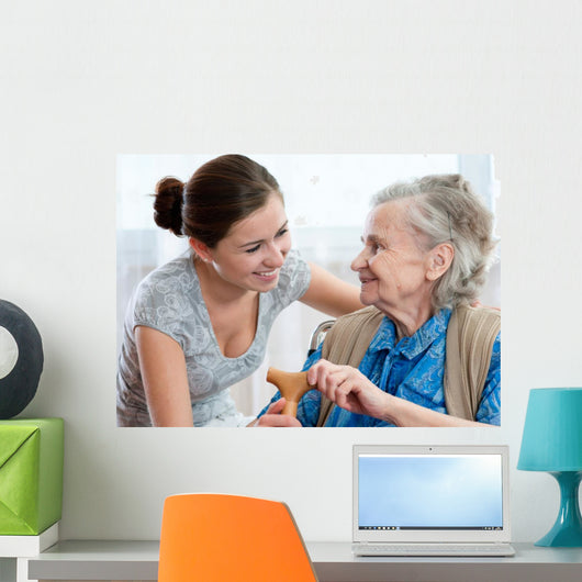 Senior woman with her home caregiver Wall Mural