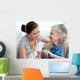 Senior woman with her home caregiver Wall Mural