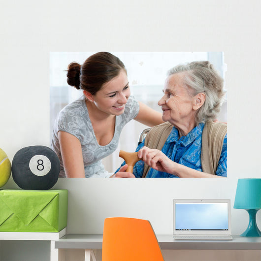 Senior woman with her home caregiver Wall Mural