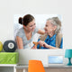 Senior woman with her home caregiver Wall Mural