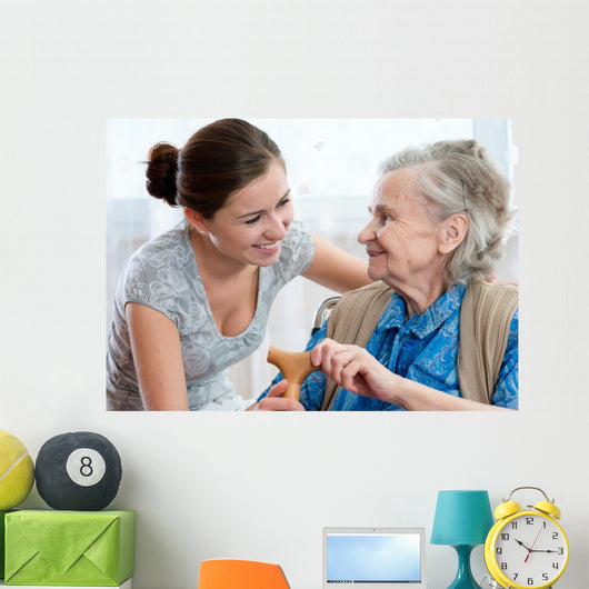 Senior woman with her home caregiver Wall Mural