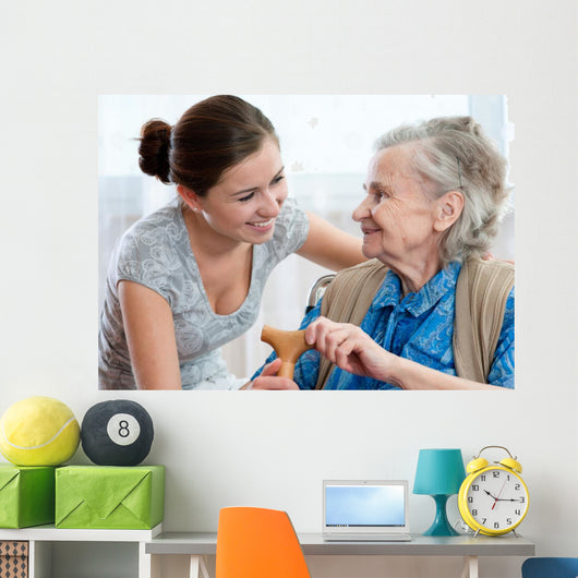 Senior woman with her home caregiver Wall Mural