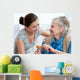 Senior woman with her home caregiver Wall Mural