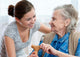 Senior woman with her home caregiver Wall Mural