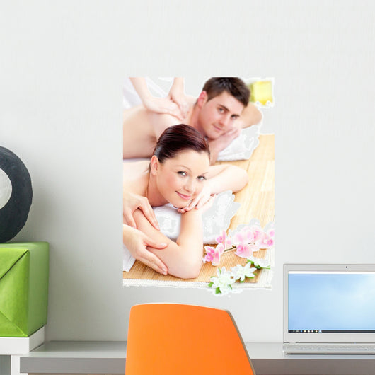 Delighted young couple receiving a back massage Wall Mural