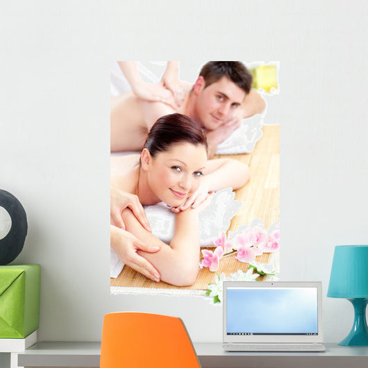 Delighted young couple receiving a back massage Wall Mural