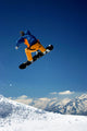 Snowboarder in Orange Jumping High Wall Mural