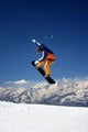 Snowboarder in Orange Jumping High Wall Mural