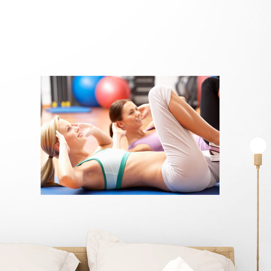 Women Doing Stretching Exercises In Gym Wall Mural