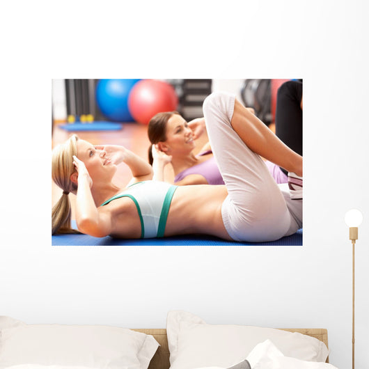Women Doing Stretching Exercises In Gym Wall Mural