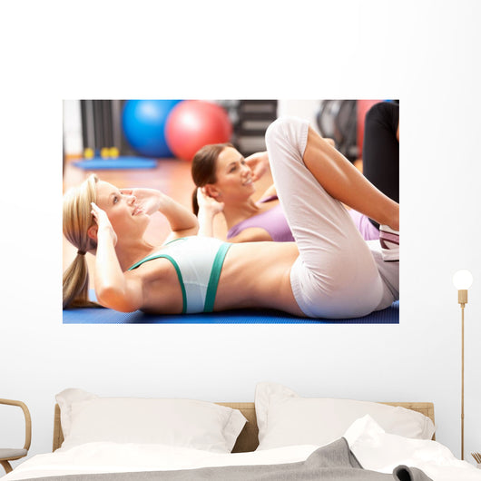 Women Doing Stretching Exercises In Gym Wall Mural