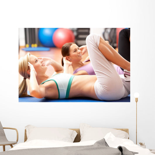Women Doing Stretching Exercises In Gym Wall Mural