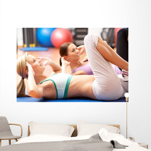 Women Doing Stretching Exercises In Gym Wall Mural