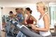 Senior Woman On Running Machine In Gym Wall Mural