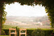Vine Covered Patio and Chairs Overlooking the Country Wall Mural