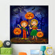 Boy and girl with pumpkins celebrates halloween. Wall Mural
