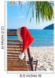 Red Santa's hat hanging on beach chair under palm tree Wall Mural