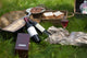 Picnic scene: wine bottles, glass, bread, boxes, still life Wall Mural