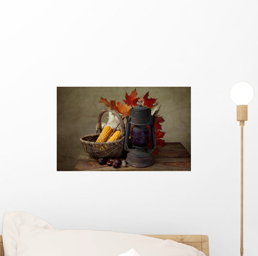 Autumn still life with kerosene lamp and corn in wicker basket Wall Mural