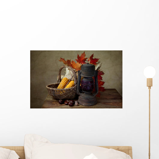Autumn still life with kerosene lamp and corn in wicker basket Wall Mural
