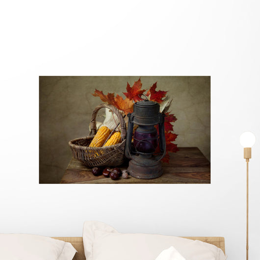 Autumn still life with kerosene lamp and corn in wicker basket Wall Mural