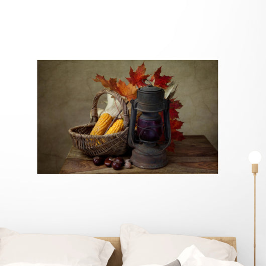 Autumn still life with kerosene lamp and corn in wicker basket Wall Mural