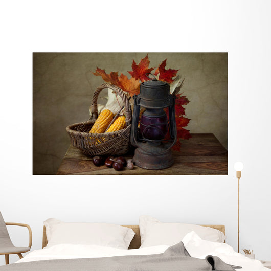 Autumn still life with kerosene lamp and corn in wicker basket Wall Mural
