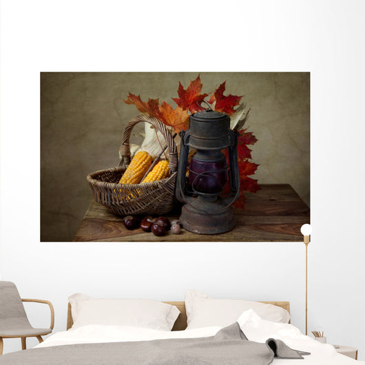 Autumn still life with kerosene lamp and corn in wicker basket Wall Mural
