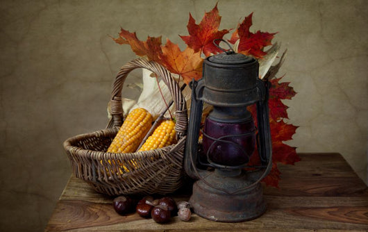 Autumn still life with kerosene lamp and corn in wicker basket Wall Mural