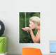 Blond woman drinking water from fountain Wall Mural