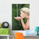 Blond woman drinking water from fountain Wall Mural