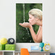 Blond woman drinking water from fountain Wall Mural