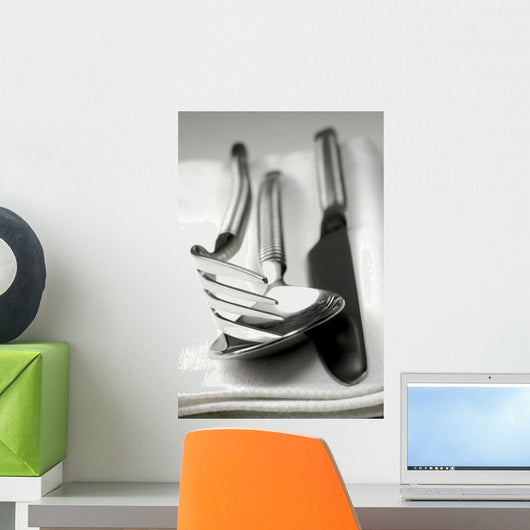 Cutlery resting on a white napkin Wall Mural