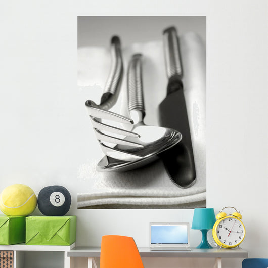 Cutlery resting on a white napkin Wall Mural