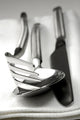 Cutlery resting on a white napkin Wall Mural