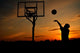 Silhouette of Teen Boy shooting a Basketball Wall Mural