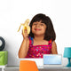 Young Girl Eating Banana Wall Decal