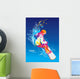 The colorful figure of a young man snowboarding on a blue sky ba Wall Mural