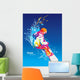The colorful figure of a young man snowboarding on a blue sky ba Wall Mural