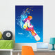 The colorful figure of a young man snowboarding on a blue sky ba Wall Mural