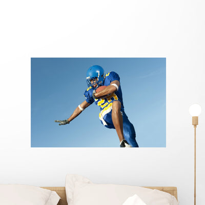 Football Player Game Action shown on a wall