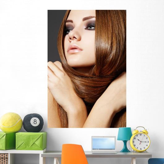 Hairstyle. Beautiful model with long shiny hair Wall Mural