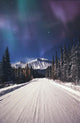 Northern Lights Over A Snowy Road Wall Mural