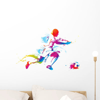 Soccer Player Kicks Ball Wall Decal shown on a wall