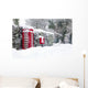 Red telephone and post box in the snow Wall Mural