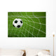 Goal. a soccer ball in a net. Wall Mural