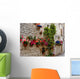 Colorful flowers lining a medieval stone wall in Italy Wall Mural