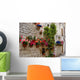 Colorful flowers lining a medieval stone wall in Italy Wall Mural