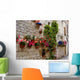 Colorful flowers lining a medieval stone wall in Italy Wall Mural