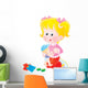 Girl playing with her doll Wall Decal